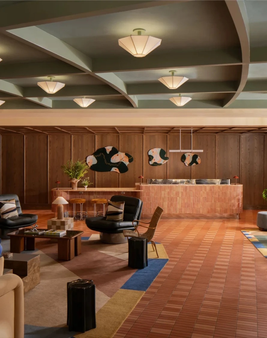 The lobby of Hotel Indigo Raleigh Downtown with warm mid-century furnishings and curved architecture